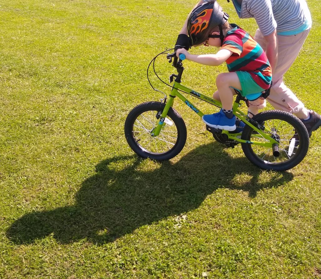 Me riding a bike with help from Mummy.