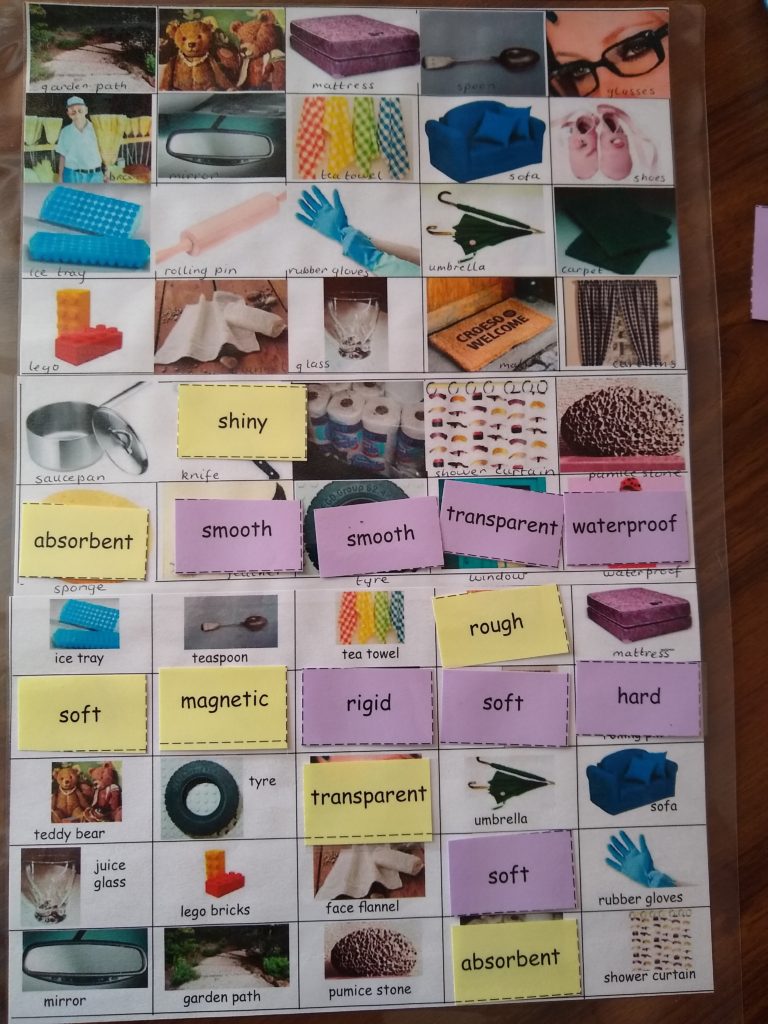 A picture board full of different objects, and eight purple cards and seven yellow cards of material properties.