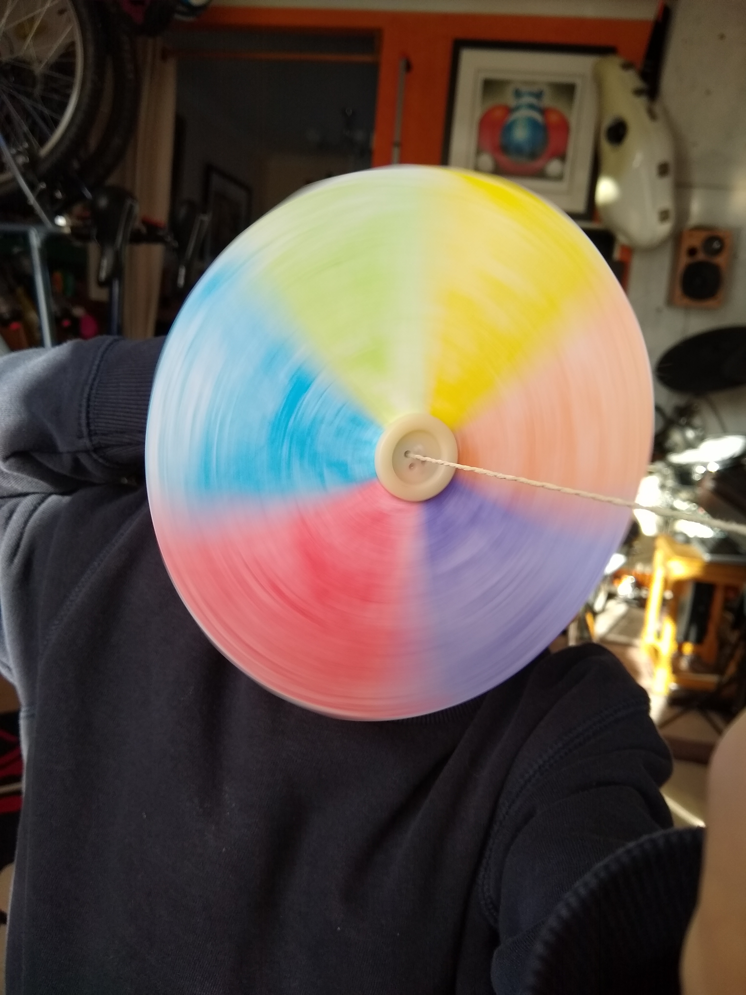 A photo of me making the colours of the rainbow spin white.