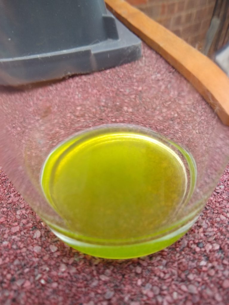 A photo of a glass with green liquid in.