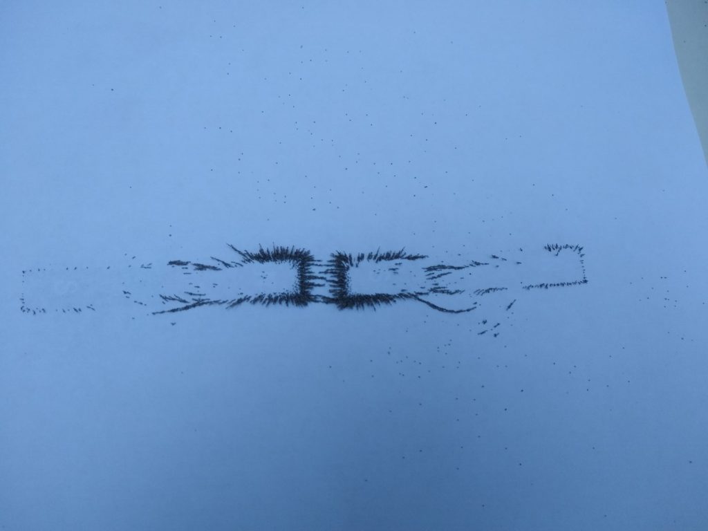 A photo of a magnetic field between two magnets attracting.