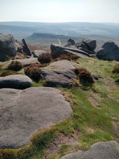 A photo of the path up to Higger Tor and a view from the summit over the moorland.