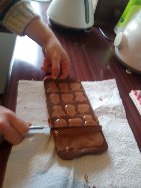 A photo of the excess chocolate is being scraped off.