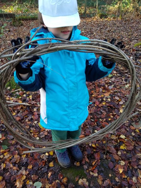 A photo of a boy holding the holy wreaf base.