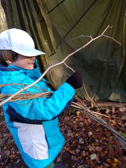 A photo of a boy wraing the branches.