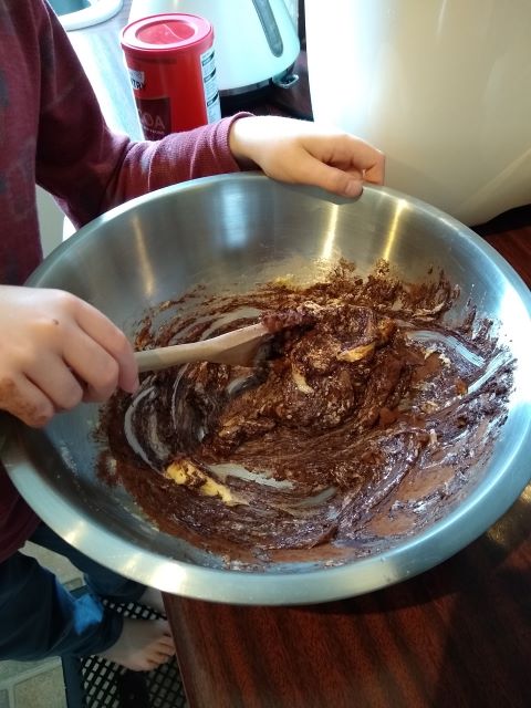 A photo of a boy stirring the mixture.