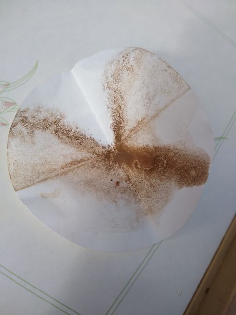 A photo of the filter paper after catching the dirt.