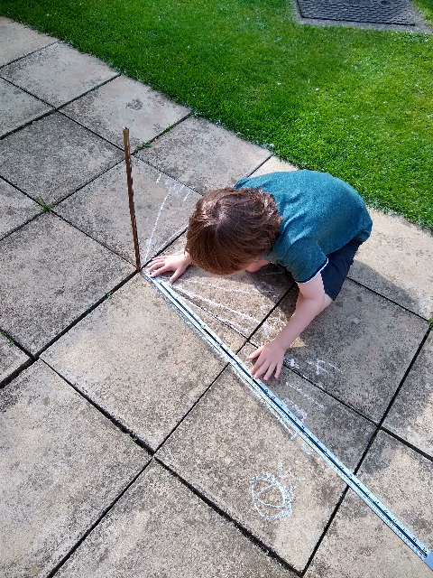 A photo of me measuring the length of the shadow.