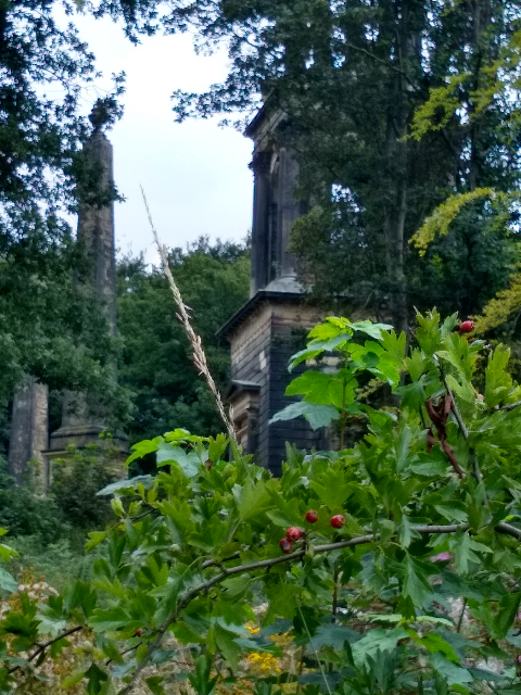 A zoomed-in photo of the mausoleum. Two towers can be seen at the entrance. The mausoleum has three storeys, the top two having pillars.